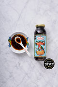Poon's London Chilli Vinegar Dressing bottle beside a dipping bowl of the sauce
